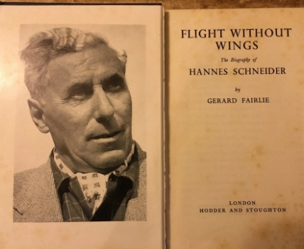 Inside pages of an old book featuring a phot of an older man and the title page that says flight without wings the biography of Hannes Schneider by Gerard Fairlie