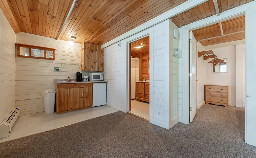 Mini kitchen in corner near door to bathroom