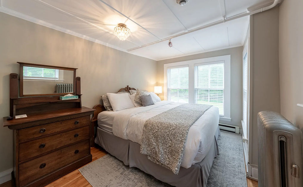 Antique dresser next to bed