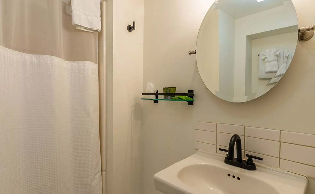 Close up of circular mirror in bathroom