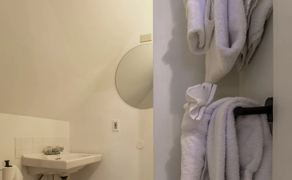 Several folded white towels in bathroom